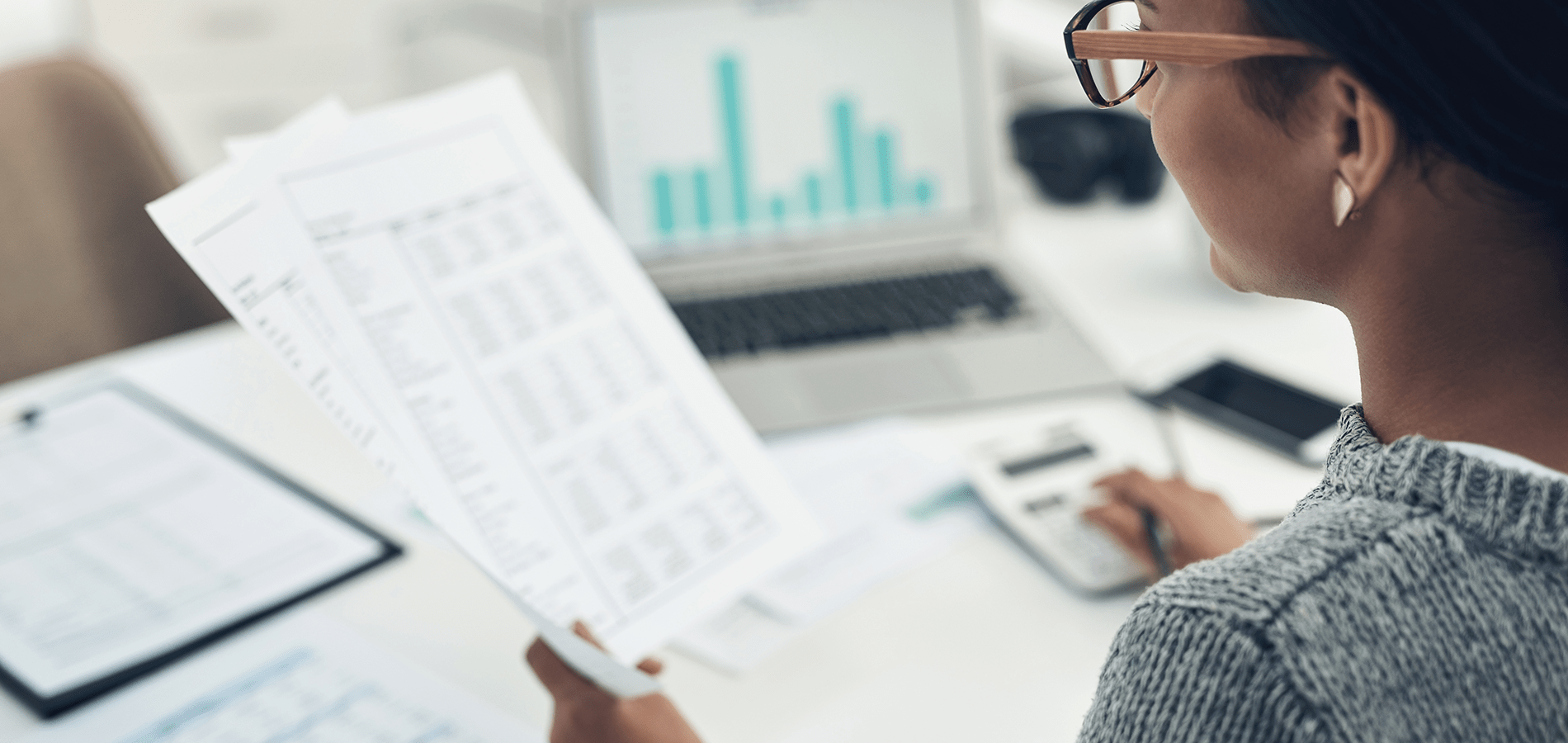 payroll worker looking at spreadsheet