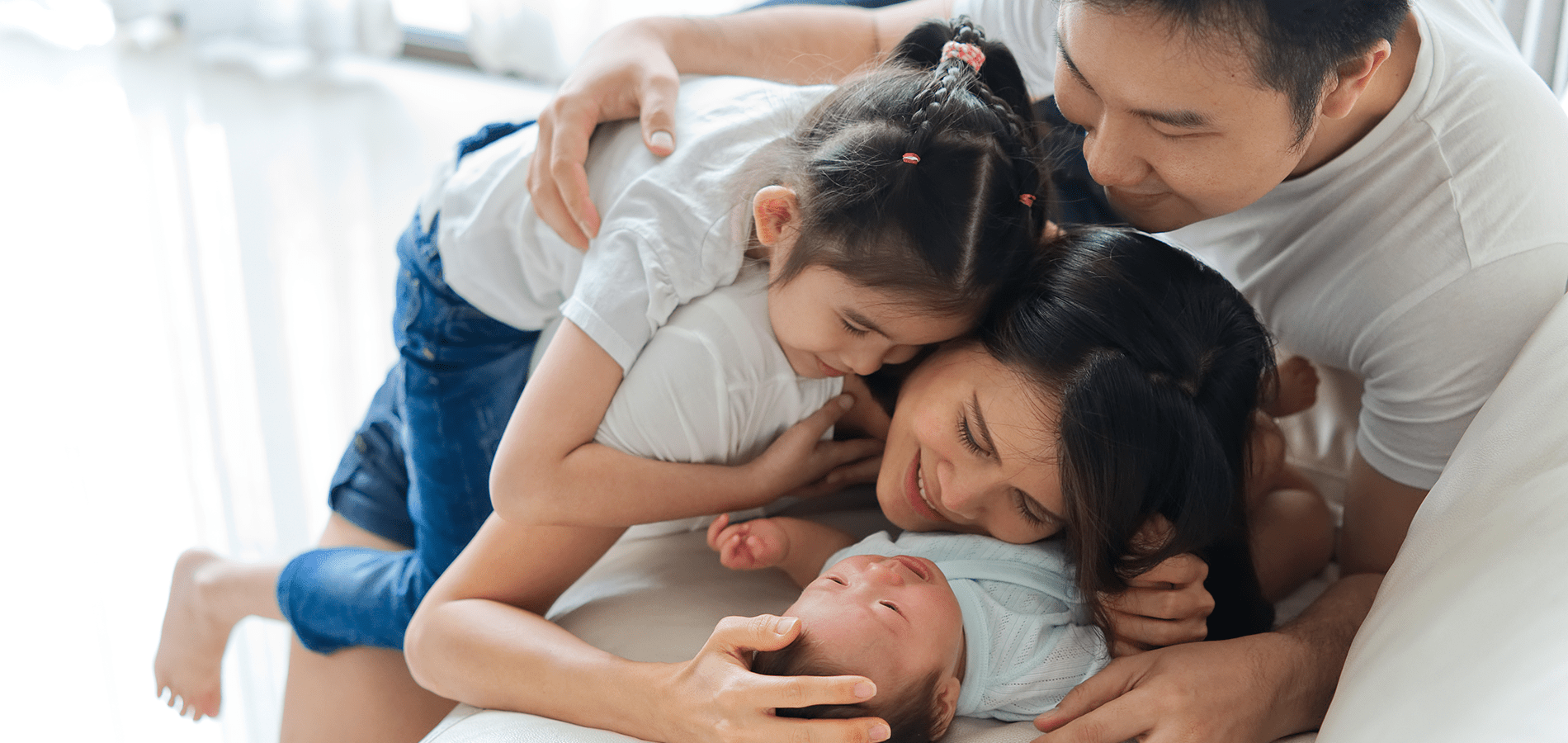 a family cuddling a newborn