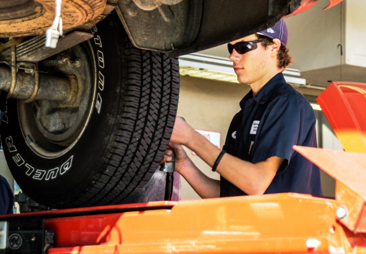 A North Orange Continuing Education students works on a car tire in Anaheim, Orange County, California