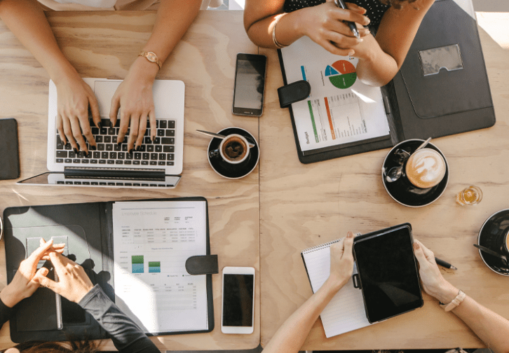 four people at a table working