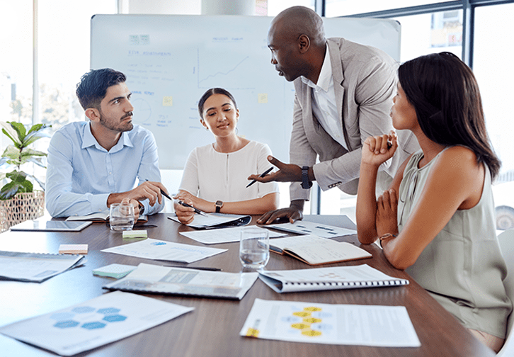 four people at a table working