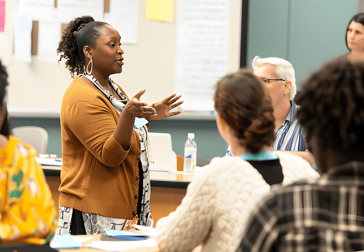 person teaching heading a discusssion in the classroom