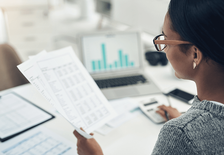 employee going over spreadsheet with calculator