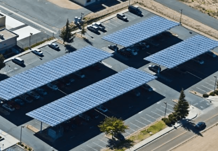 birds' eye view of solar panels covering parking spots