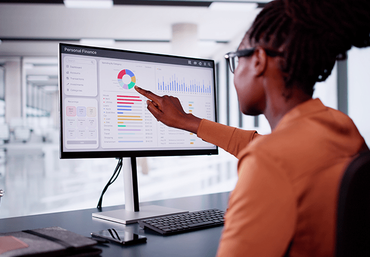 woman at computer looking at budget graphics