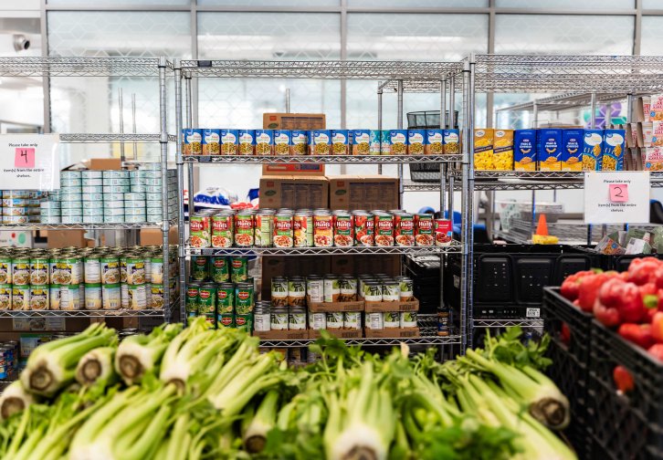 canned vegetables on shelves and fresh produce in crates