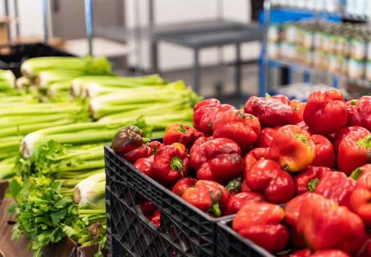 crates of celery and bell peppers