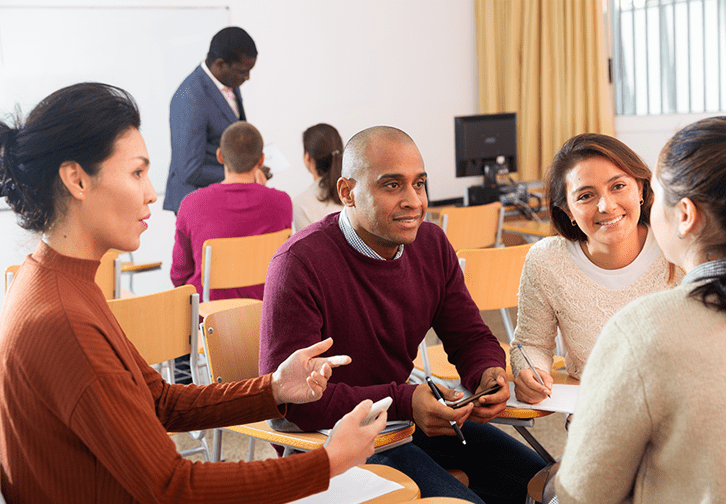 adults seated together collaborating in a classroom