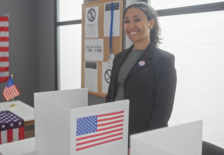 Smiling woman at a voting booth