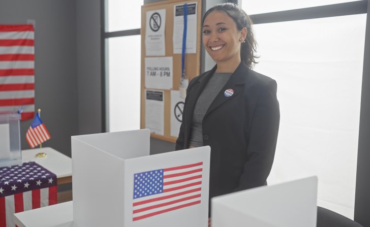 Smiling woman at a voting booth