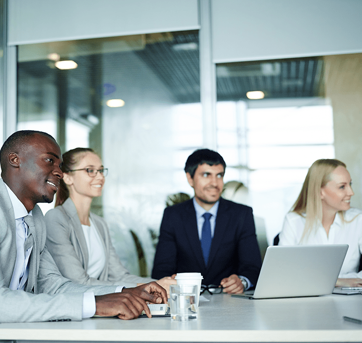 four people at a table working