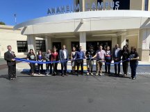 Group outside the Anaheim Campus entrance holding a ribbon