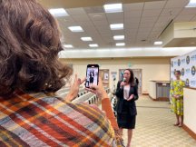 Natalie Rubalcava with microphone while being filmed 