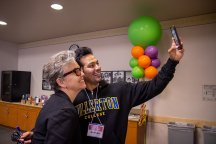 Two staff members take a selfie at Fullerton College celebration