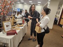 two people have a conversation at a wellness information table