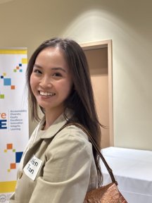 woman with nametag smiling at camera