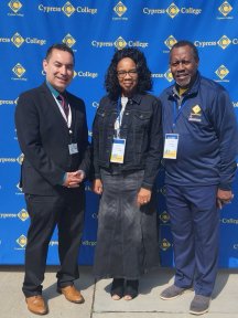 Three members of the Faculty Fellows program in front of a Cypress College backdrop